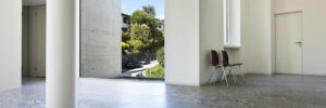 Granite floors stand out against white, neutral-toned walls in an office building.